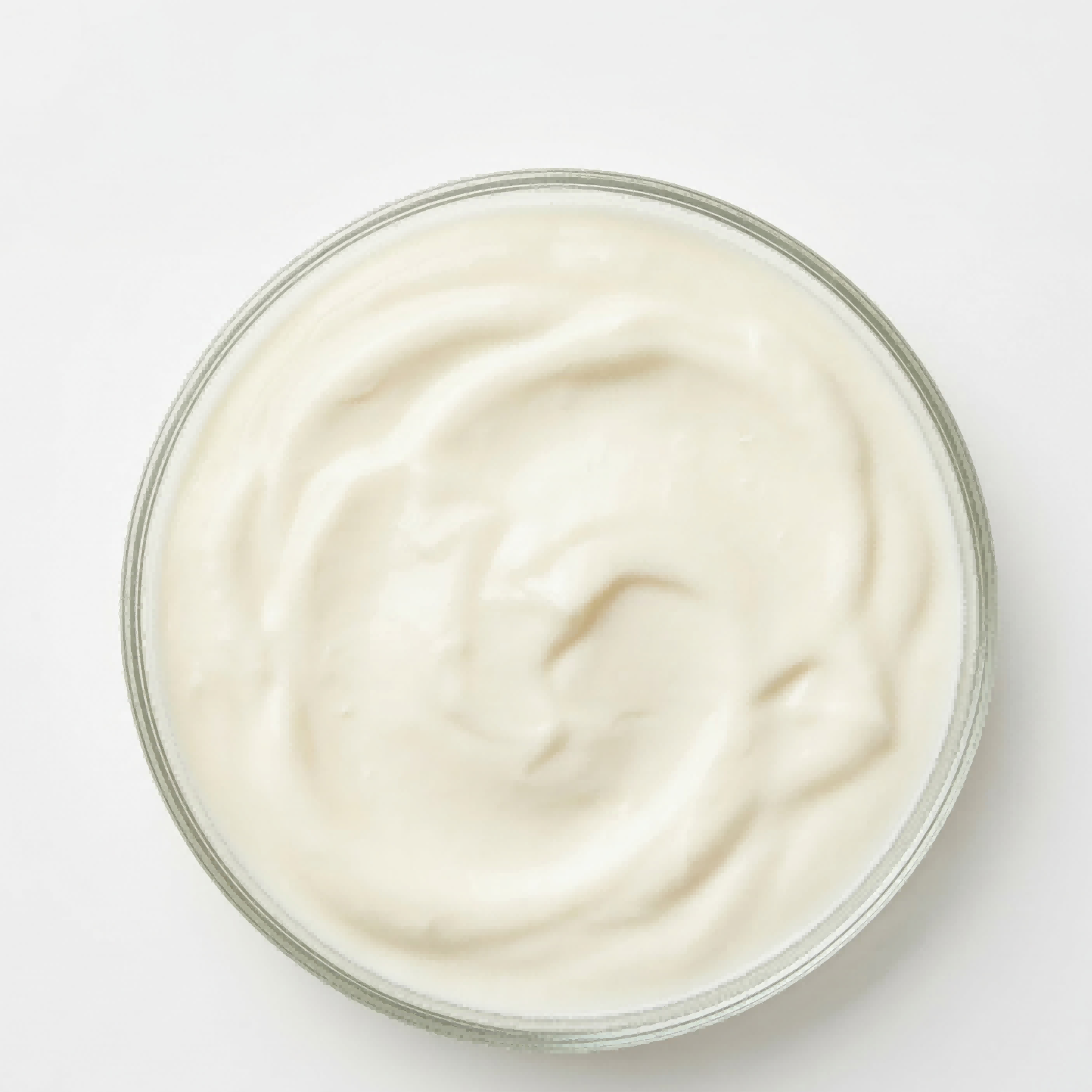 Glass bowl filled with creamy white substance on a light gray background